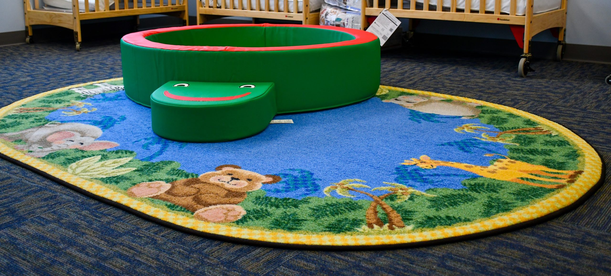 A cozy infant padded gym to allow them to safely practice their motor skills early on while in our child care centers.